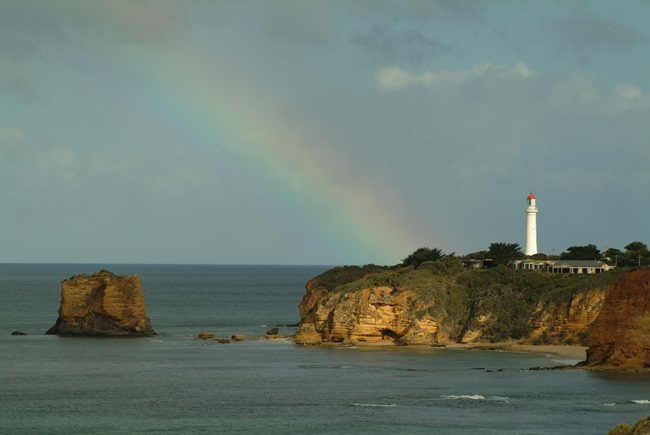 Natural spotlight on the cliff face at Split Point Lighthouse, Aireys Inlet, Great Ocean Road, Victoria, Australia.
