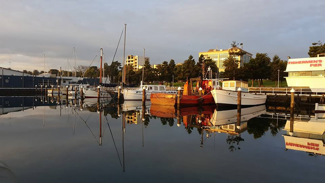 Fishing boats on a quiet morning, Geelong, Victoria, Australia. Quiet morning reflections at the waterfront in Geelong.