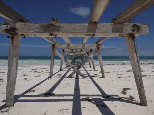 Looking underneath the abandoned jetty from the land, at Eucla, Western Australia.