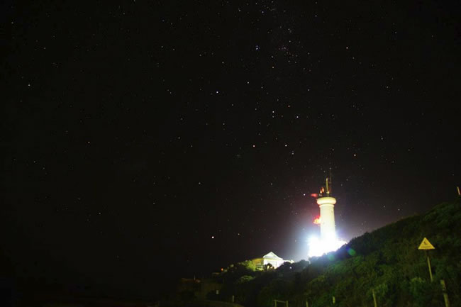 A lit up Point Lonsdale Lighthouse, with a starry night sky as a background, Bellarine Peninsula, Victoria, Australia.