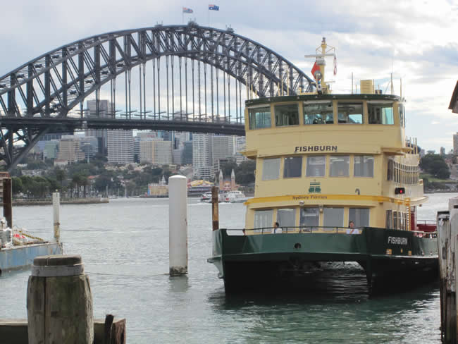 The Sydney Harbour Bridge with a Sydney ferry in the foreground, as seen from Circular Quay. Sydney, New South Wales, Australia