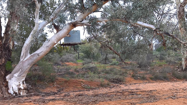 Water tank alongside a dry river bed, Silverton, New South Wales Australia.