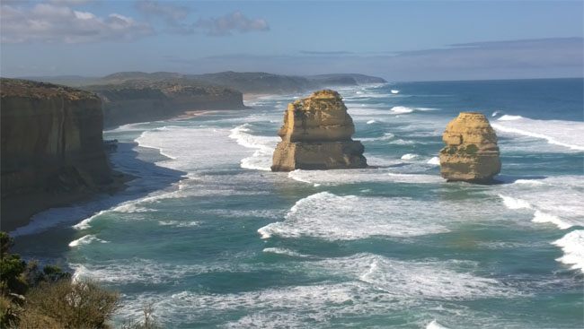 Sunlit Twelve Apostles in wild weather, Great Ocean Road, Victoria, Australia.