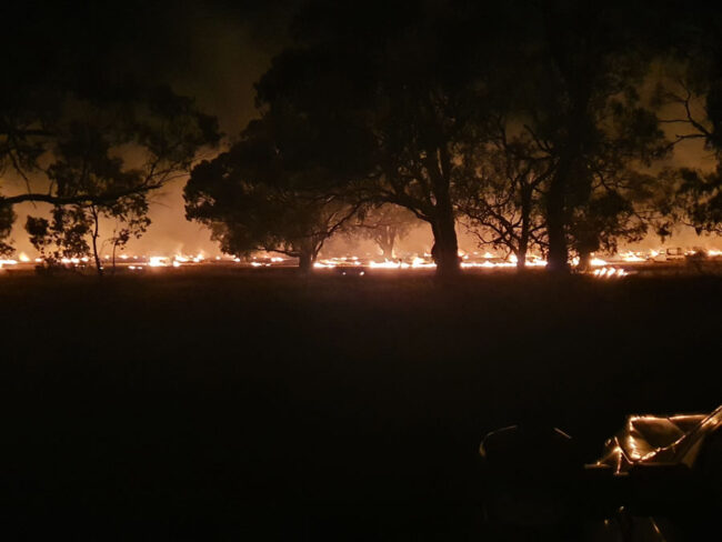 Late in the night the farmers were still carefully watching the stubble fire.